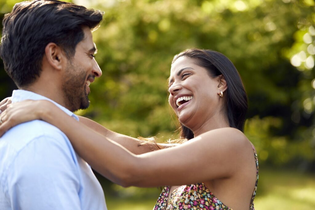 Portrait Of Loving Couple Outdoors In Garden Or Countryside